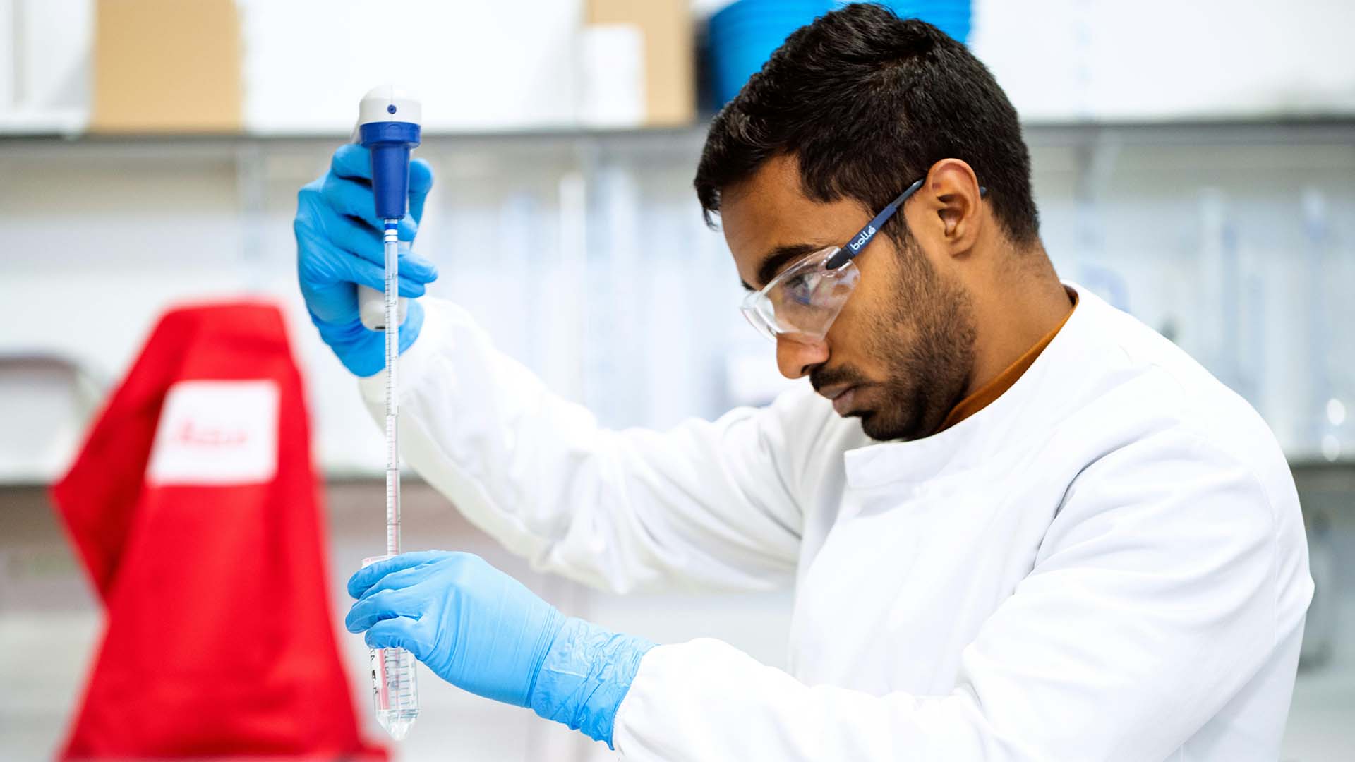 a scientist handling chemicals in a laboratory