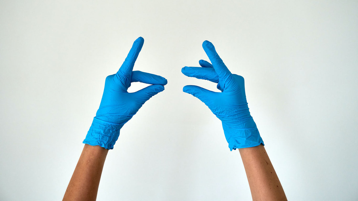 gloved hands reaching into the air