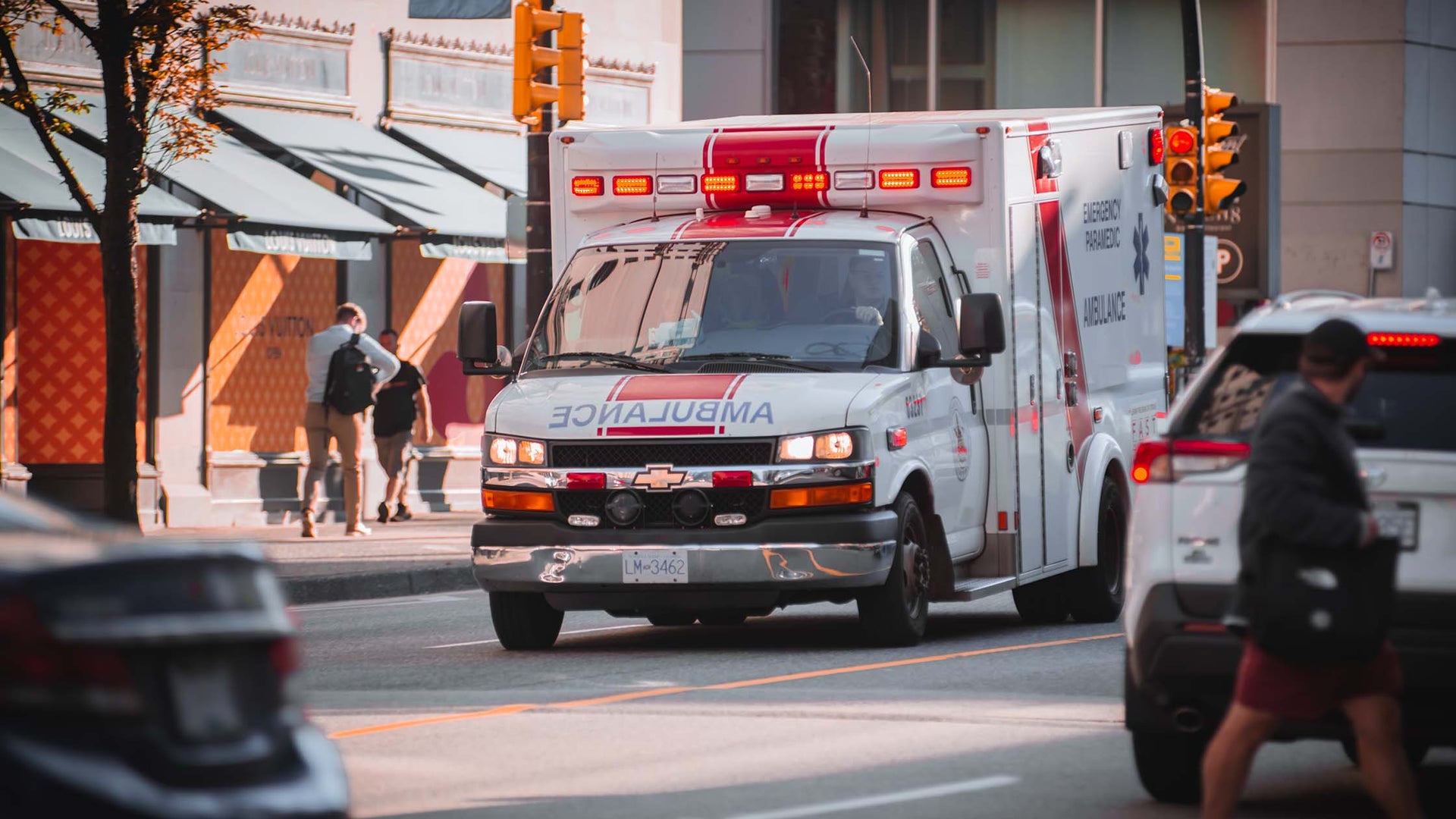 a first responder ambulance driving down on a busy street