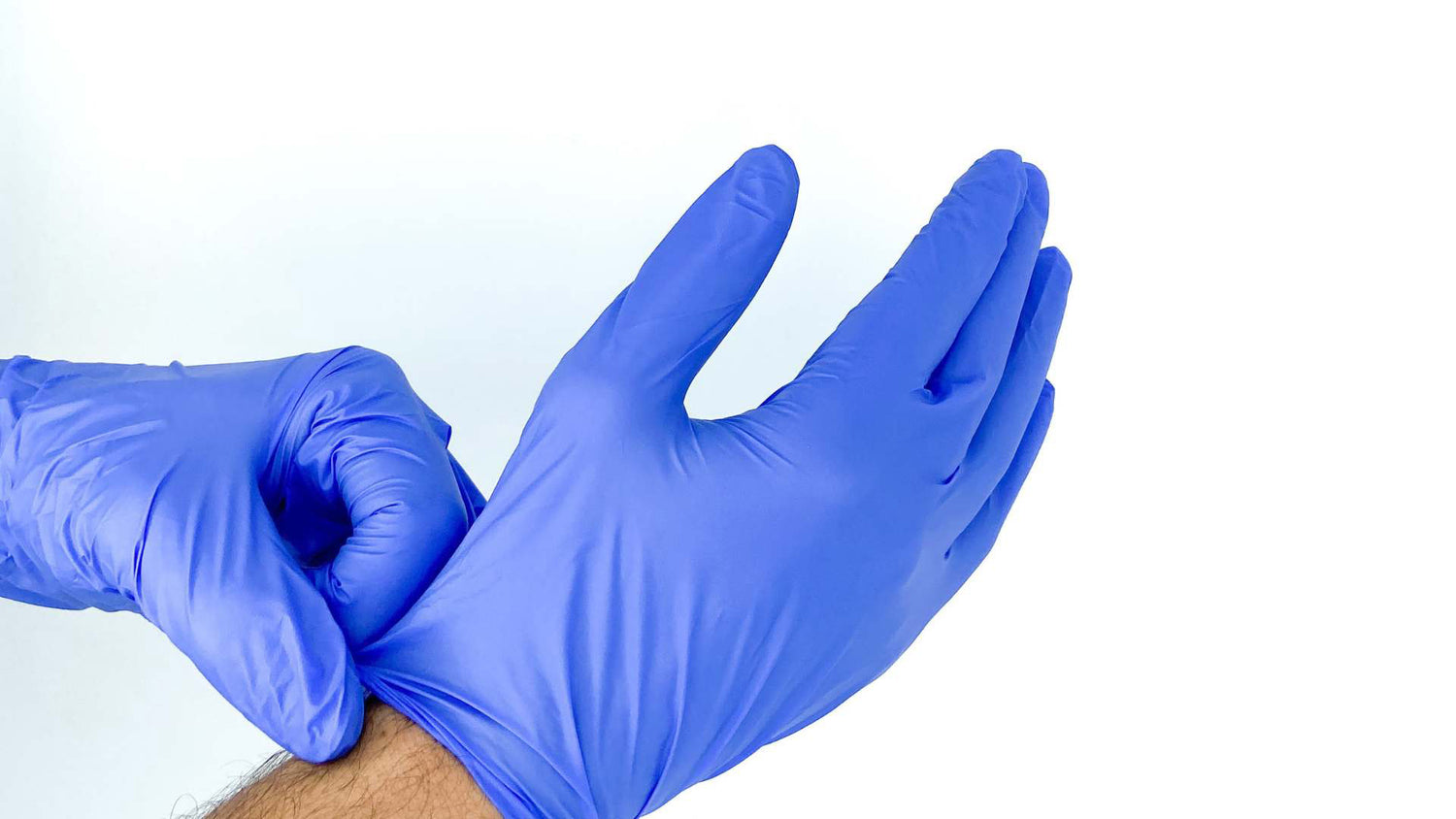 Person putting on blue disposable gloves