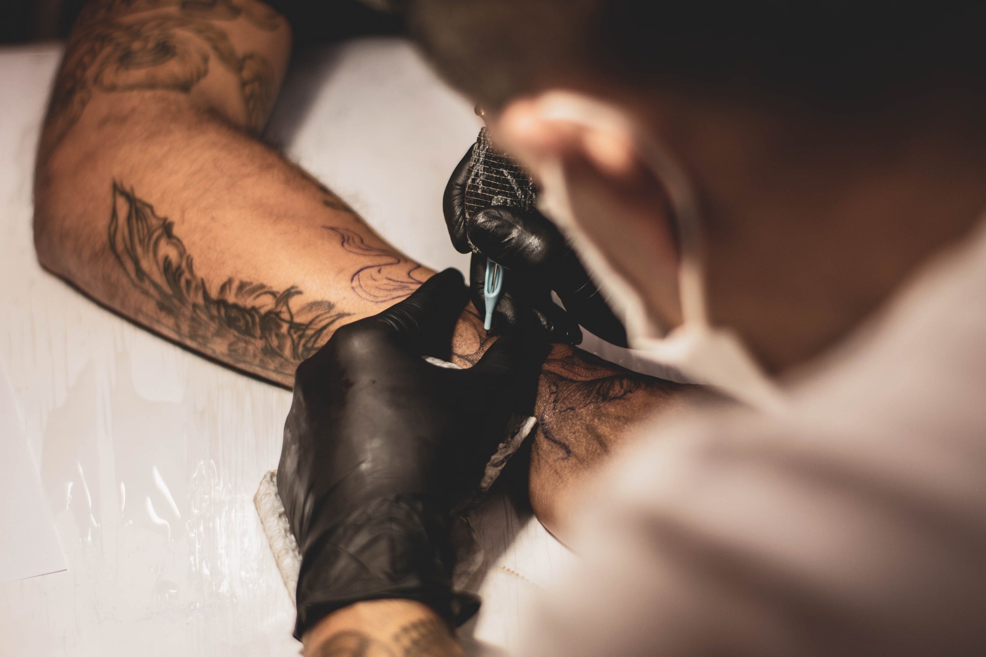 The Reasons Why Tattoo Artists Wear Black Gloves