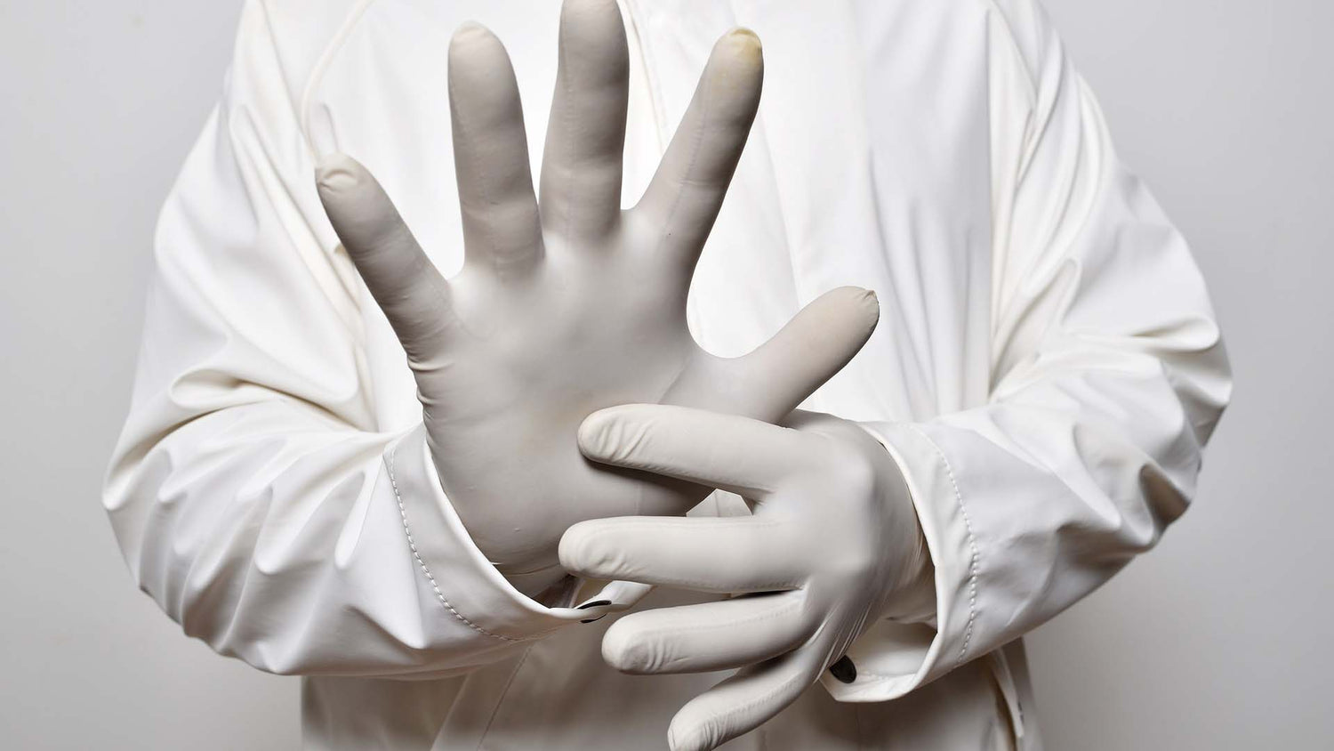 person wearing white nitrile gloves
