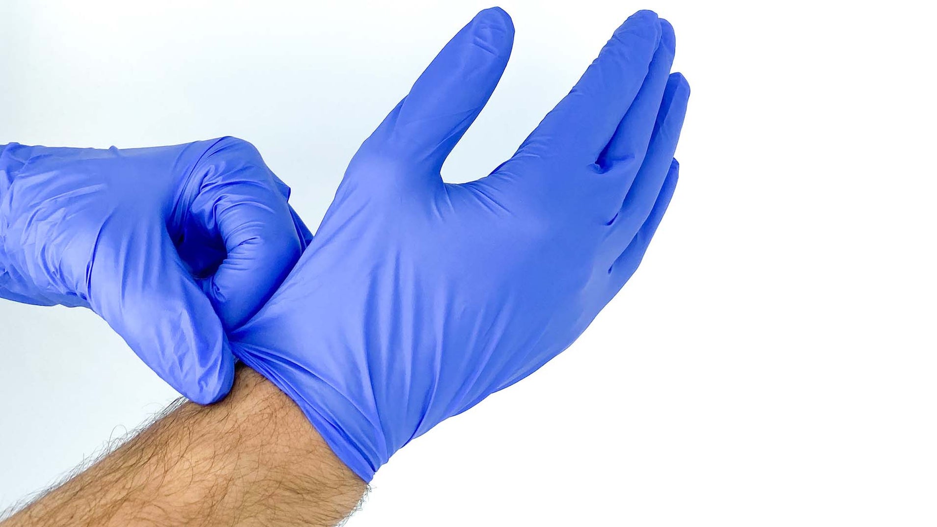 person putting on blue nitrile gloves