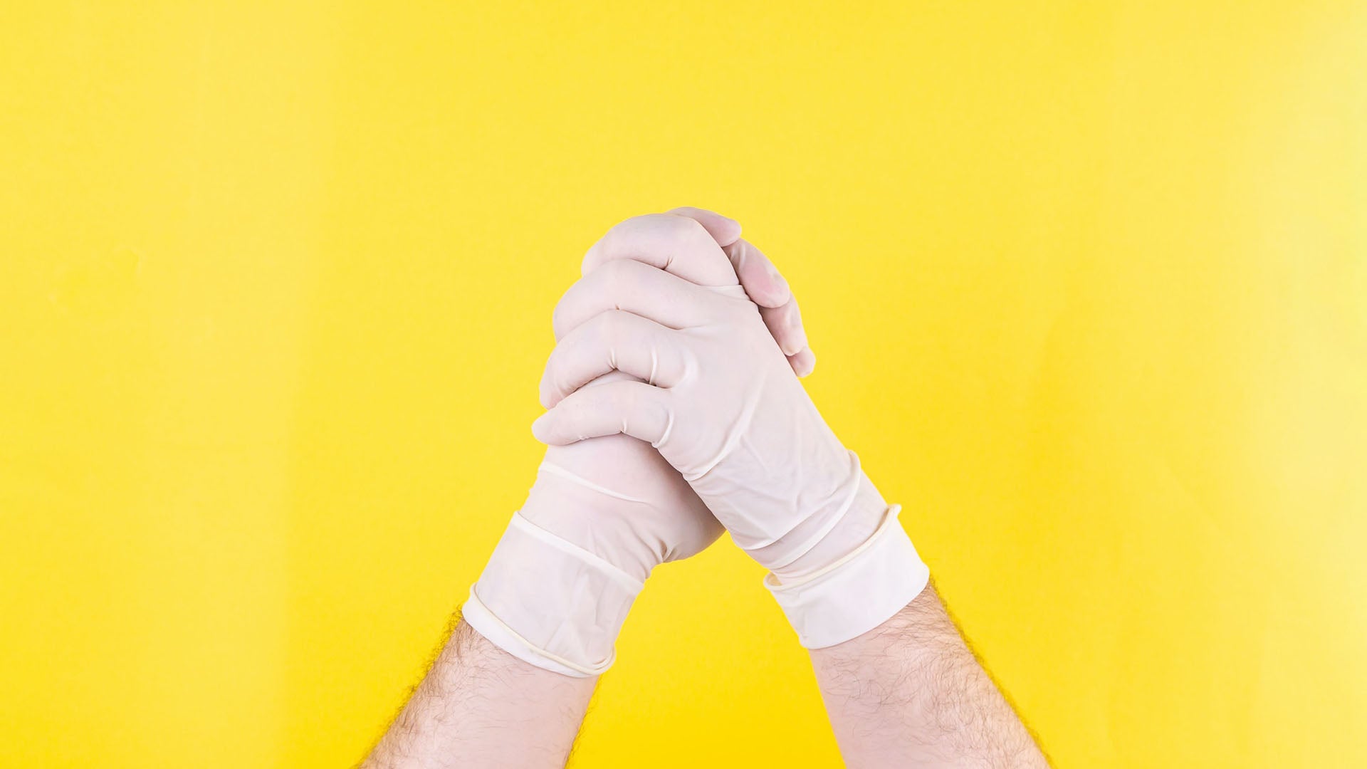hands wearing white latex gloves